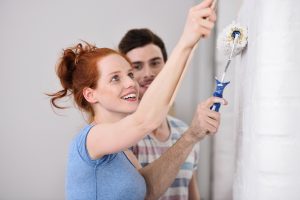 Man and women painting together